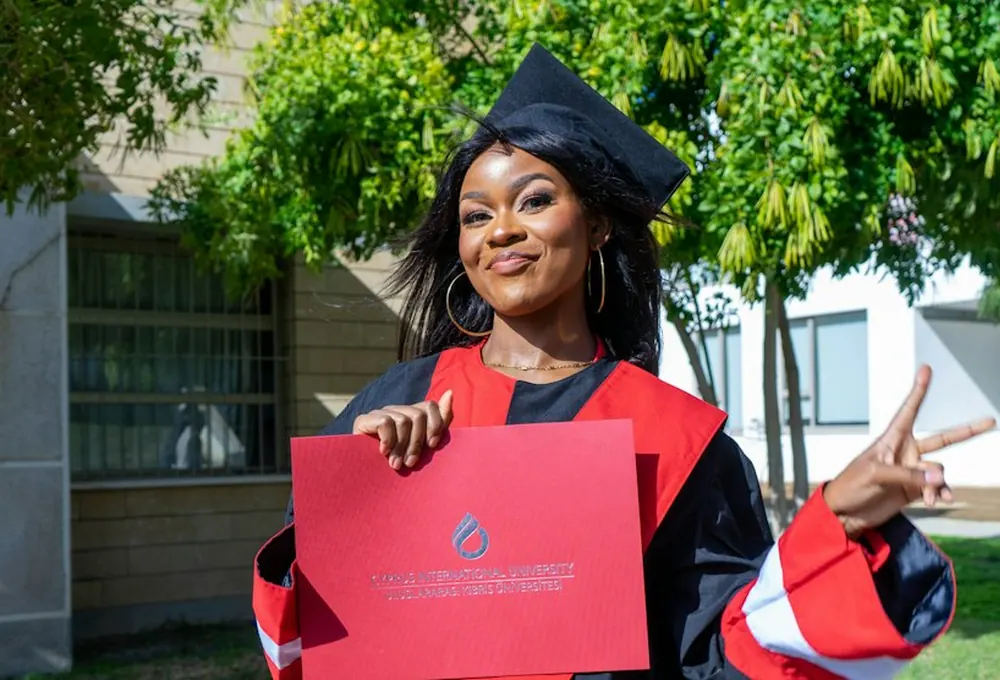 A graduate holding her certificate